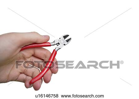 Stock Photo - Cropped image of hand holding pliers over white background. Fotosearch
