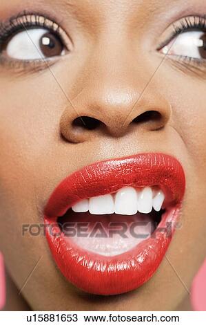 Cropped image of shocked young woman with red lips looking to her side View Large Photo Image Stock Image - Cropped image of shocked young woman with red lips looking to her side. Fotosearch