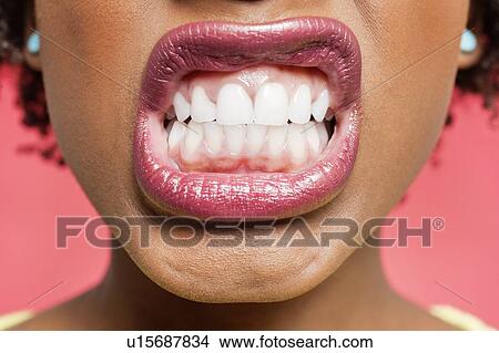 Cropped image of woman clenching teeth View Large Photo Image Picture - Cropped image of woman clenching teeth. Fotosearch