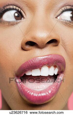 Detail shot of a shocked young woman looking to her side View Large Photo Image Stock Photograph - Detail shot of a shocked young woman looking to her side. Fotosearch