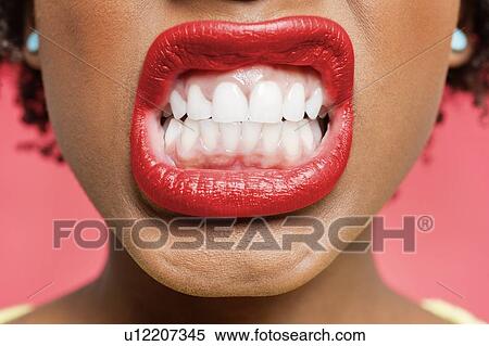 Detail shot of woman clenching teeth View Large Photo Image Stock Photography - Detail shot of woman clenching teeth. Fotosearch