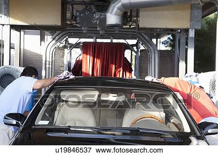Employees wiping vehicle in car wash View Large Photo Image Stock Photo - Employees wiping vehicle in car wash. Fotosearch