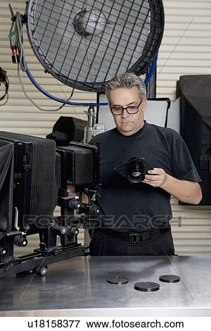 Front view of a technician in photographer's studio View Large Photo Image Stock Photo - Front view of a technician in photographer's studio. Fotosearch