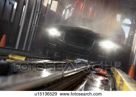 Stock Photo - Front view of car passing through car wash process. Fotosearch