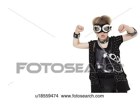 Picture - Front view of punk kid wearing pilot goggles with raised fist over white background. Fotosearch