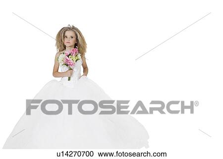 Stock Image - Girl in wedding dress holding flower bouquet while looking away over white background. Fotosearch