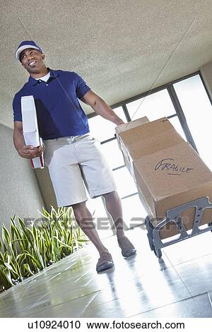 Stock Image - Happy African American delivery man. Fotosearch