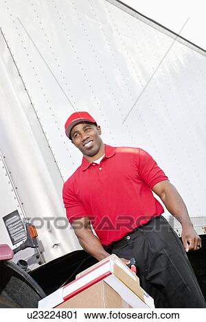 Happy African American delivery man pushing handtruck View Large Photo Image Stock Image - Happy African American delivery man pushing handtruck. Fotosearch