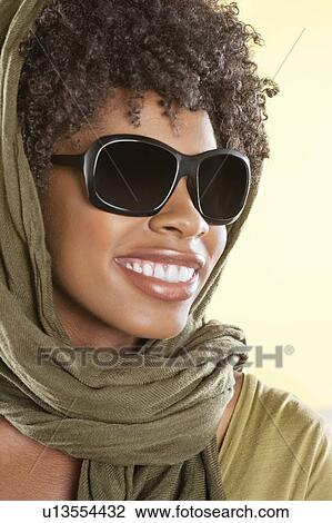 Happy African American wearing sunglasses with stole over her head View Large Photo Image Stock Image - Happy African American wearing sunglasses with stole over her head. Fotosearch