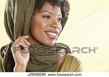 Happy African American woman with a stole over head looking away View Large Photo Image Stock Photo - Happy African American woman with a stole over head looking away. Fotosearch
