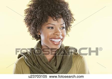 Happy African American woman with a stole round her neck looking away over colored background View Large Photo Image Stock Photography - Happy African American woman with a stole round her neck looking away over colored background. Fotosearch
