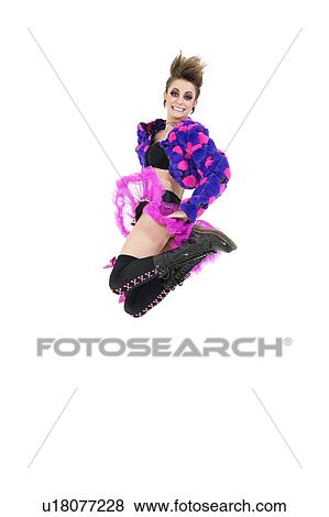 Stock Photo - Happy young punk woman jumping over white background. Fotosearch