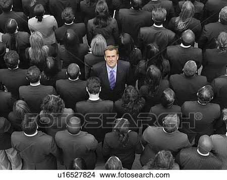 High angle view of a businessman standing amidst businesspeople View Large Photo Image Picture - High angle view of a businessman standing amidst businesspeople. Fotosearch