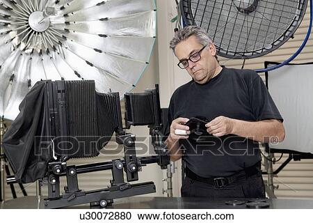 Mature man standing in photographer's studio View Large Photo Image Stock Image - Mature man standing in photographer's studio. Fotosearch