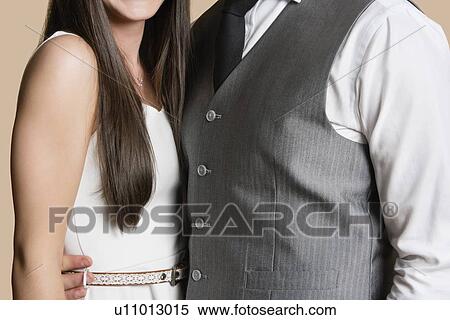Midsection of casually dressed young couple View Large Photo Image Stock Photography - Midsection of casually dressed young couple. Fotosearch
