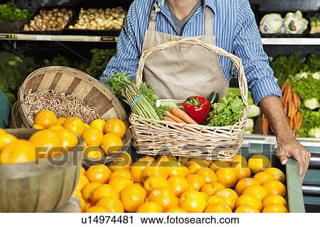 Midsection of man standing near oranges stall with vegetable basket in supermarket View Large Photo Image Stock Image - Midsection of man standing near oranges stall with vegetable basket in supermarket. Fotosearch