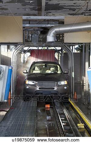Stock Photo - Motor vehicle passing through car wash. Fotosearch