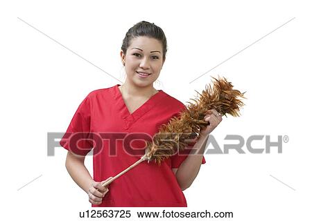 Stock Photography - Native American house cleaner holding feather duster over white background. Fotosearch