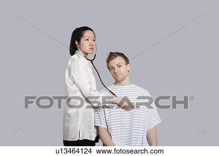 Patient being examined by the doctor View Large Photo Image Picture - Patient being examined by the doctor. Fotosearch