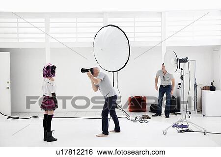 Photographer shooting fashion model in photo shoot View Large Photo Image Stock Photograph - Photographer shooting fashion model in photo shoot. Fotosearch