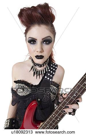 Portrait beautiful punk woman staring while holding guitar over white background View Large Photo Image Stock Image - Portrait beautiful punk woman staring while holding guitar over white background. Fotosearch