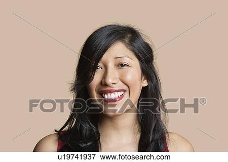 Stock Photo - Portrait of a beautiful happy woman over colored background. Fotosearch