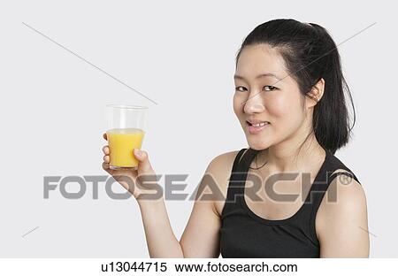 Portrait of a beautiful woman having a glass of orange juice View Large Photo Image Stock Photography - Portrait of a beautiful woman having a glass of orange juice. Fotosearch