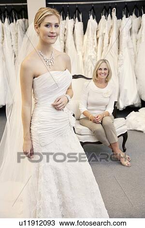 Portrait of a beautiful young woman in wedding dress with mother sitting background View Large Photo Image Stock Image - Portrait of a beautiful young woman in wedding dress with mother sitting background. Fotosearch