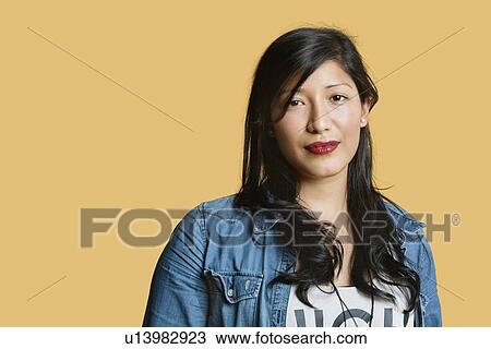 Portrait of a beautiful young woman over colored background View Large Photo Image Stock Image - Portrait of a beautiful young woman over colored background. Fotosearch