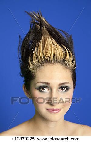 Portrait of a beautiful young woman with spiked hair over colored background View Large Photo Image Stock Photography - Portrait of a beautiful young woman with spiked hair over colored background. Fotosearch