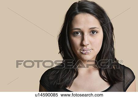 Portrait of a beautiful young woman with sprinkled lips over colored background View Large Photo Image Stock Photography - Portrait of a beautiful young woman with sprinkled lips over colored background. Fotosearch