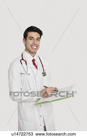 Portrait of a cheerful Indian male doctor holding a medical chart over light gray background View Large Photo Image Stock Image - Portrait of a cheerful Indian male doctor holding a medical chart over light gray background. Fotosearch