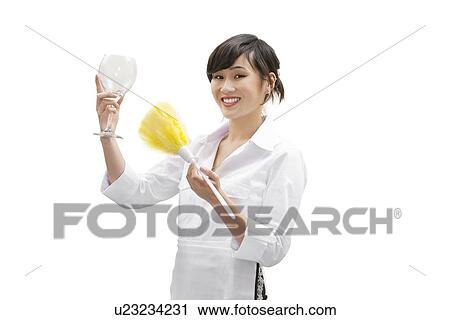 Portrait of a happy female house cleaner dusting glass with feather duster over white background View Large Photo Image Stock Image - Portrait of a happy female house cleaner dusting glass with feather duster over white background. Fotosearch