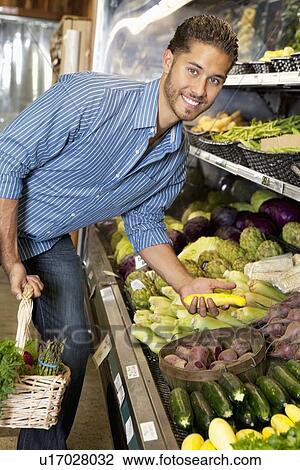 Portrait of a happy man shopping for vegetables in market View Large Photo Image Stock Image - Portrait of a happy man shopping for vegetables in market. Fotosearch