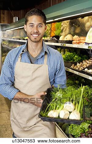 Portrait of a happy man with basket full of green onion in supermarket View Large Photo Image Stock Image - Portrait of a happy man with basket full of green onion in supermarket. Fotosearch