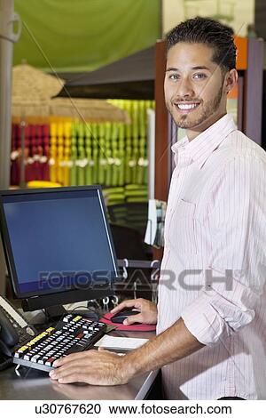Stock Image - Portrait of a happy salesperson in store. Fotosearch