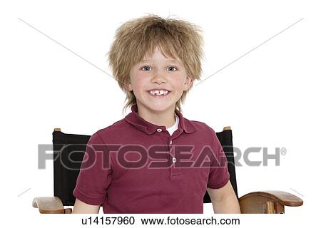 Portrait of a happy school boy sitting on director's chair over white background View Large Photo Image Stock Image - Portrait of a happy school boy sitting on director's chair over white background. Fotosearch
