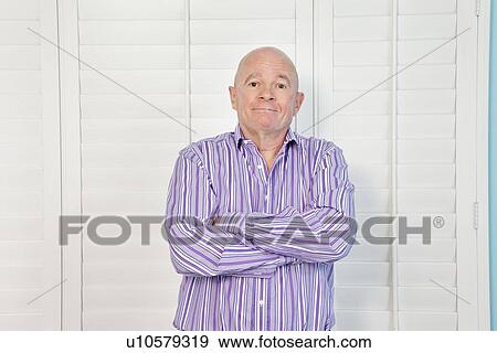 Portrait of a happy senior man with arms crossed View Large Photo Image Stock Photo - Portrait of a happy senior man with arms crossed. Fotosearch