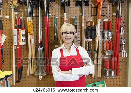 Portrait of a happy senior woman with arms crossed in front of gardening tool View Large Photo Image Stock Photograph - Portrait of a happy senior woman with arms crossed in front of gardening tool. Fotosearch