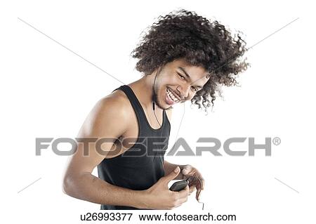 Portrait of a happy young man with mp3 player over white background View Large Photo Image Stock Photo - Portrait of a happy young man with mp3 player over white background. Fotosearch