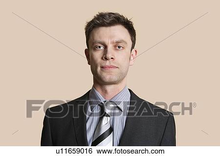 Stock Photograph - Portrait of a mid adult business professional over colored background. Fotosearch