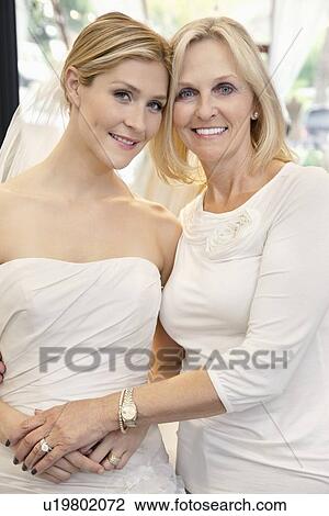 Portrait of a mother with daughter dressed as bride in bridal store View Large Photo Image Stock Image - Portrait of a mother with daughter dressed as bride in bridal store. Fotosearch