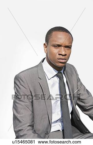 Stock Image - Portrait of a serious African American businessman over white background. Fotosearch