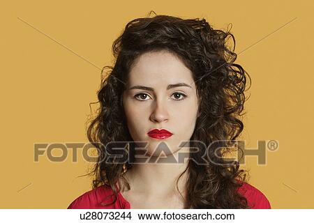 Portrait of a serious woman with black hair over colored background View Large Photo Image Picture - Portrait of a serious woman with black hair over colored background. Fotosearch