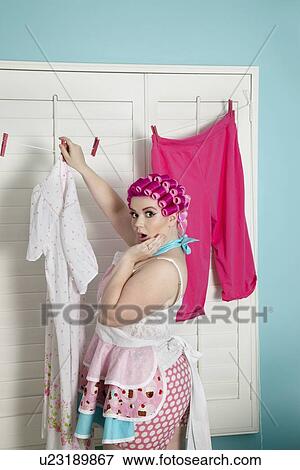 Portrait of a shocked plus-size woman drying clothes View Large Photo Image Stock Photo - Portrait of a shocked plus-size woman drying clothes. Fotosearch