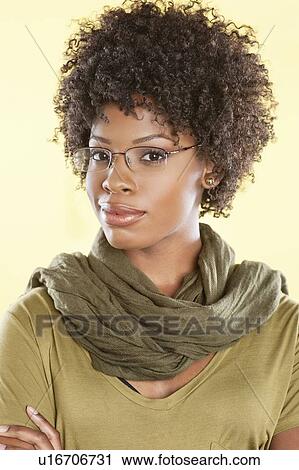 Portrait of a smart African American woman wearing glasses with a stole round her neck over colored background View Large Photo Image Stock Image - Portrait of a smart African American woman wearing glasses with a stole round her neck over colored background. Fotosearch