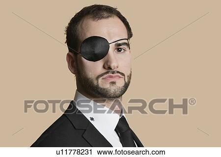 Portrait of a young businessman with eye patch over colored background View Large Photo Image Stock Image - Portrait of a young businessman with eye patch over colored background. Fotosearch