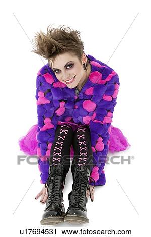 Portrait of a young punk woman sitting over white background View Large Photo Image Stock Image - Portrait of a young punk woman sitting over white background. Fotosearch