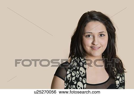 Portrait of a young woman over colored background View Large Photo Image Stock Photograph - Portrait of a young woman over colored background. Fotosearch