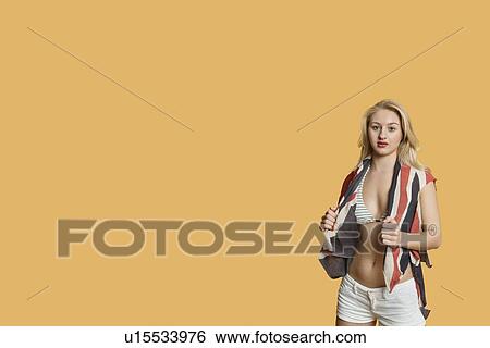 Stock Photograph - Portrait of a young woman with British flag over colored background. Fotosearch